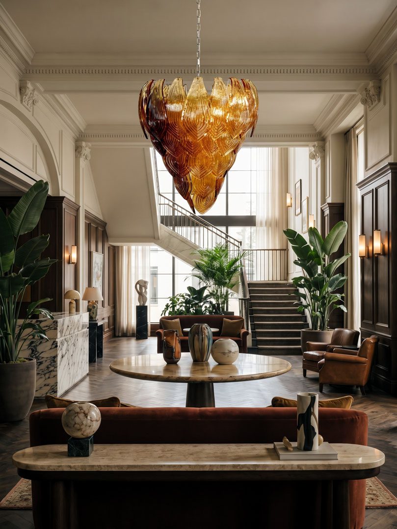 52 amber felci Murano glass chandelier hanging in a hotel lobby